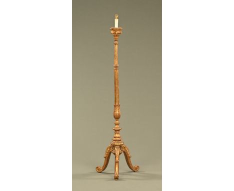 A continental giltwood and gesso lamp standard, raised on cabriole legs terminating in scroll feet.  Height 163 cm.