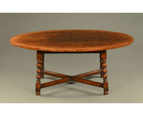 A Titchmarsh & Goodwin style oak dining table, oval, raised on bobbin turned slightly splayed legs with stretchers.  Height 7