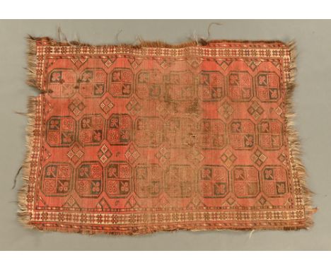 An antique Persian rug, the centre rectangular panel with three rows of repeating designs and with multiple line border and f