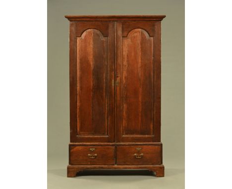 An 18th century Georgian oak arched panel raised aND fielded linen press.  Height 192 cm, width 117 cm, depth 48 cm. 