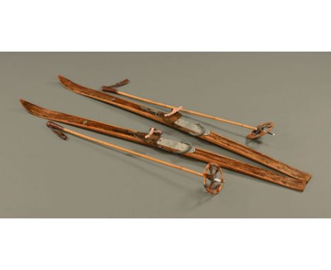 A pair of vintage Sport-Hackl wooden skis with Kandahar fittings, together with poles.
