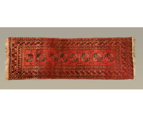 An Eastern thick pile heavy runner, the centre rectangular panel with eight repeating motifs and with multiple line border, p