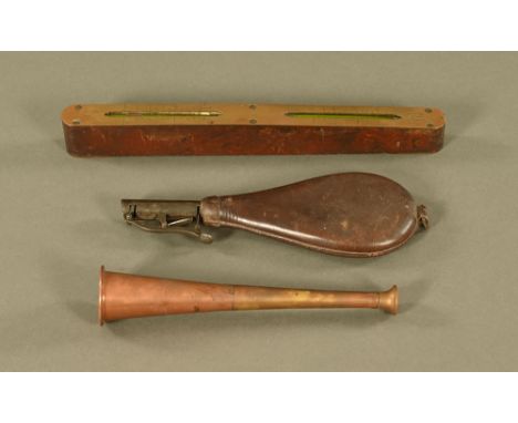 A leather shot flask, a small brass and copper hunting horn and a double B.R./W. 1955 spirit level.