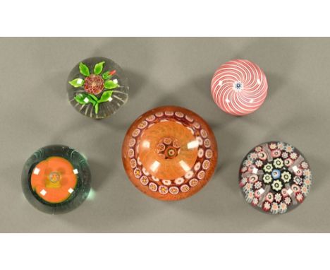 Five paperweights, three Millefiori, largest diameter 10 cm. CONDITION REPORT: The inkwell paperweight has chips and nibbles 