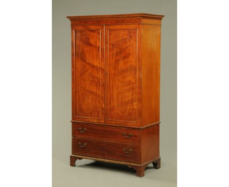 An Edwardian inlaid mahogany George III style wardrobe on chest, with blind dentil cornice above a crossbanded strung frieze 