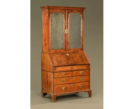 An early 18th century walnut bureau bookcase, with original Vauxhall glass plates and original stepped interior.  Height 208 