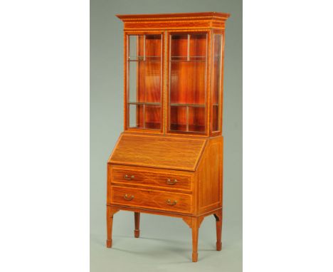 An Edwardian inlaid mahogany bureau bookcase, the top half with a moulded blind dentil cornice above a pair of glazed doors, 