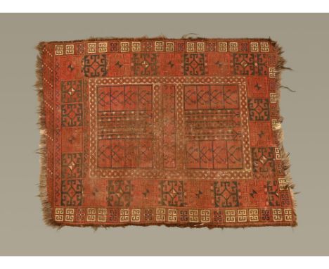 An Eastern fringed rug, with centre rectangular panel with book form motif and multiple line border, principal colours red, b