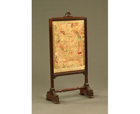 A 19th century tapestry fire screen, with rise and fall action.  Height 102 cm, width 49 cm.