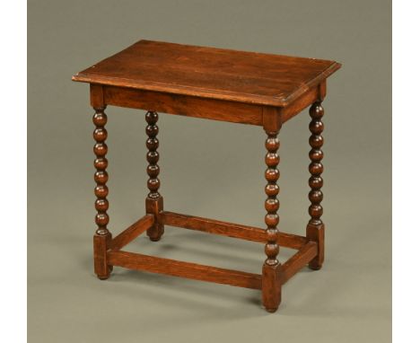 An oak occasional table, with bobbin turnings and low stretchers.  Height 59 cm, width 60 cm, depth 37 cm.