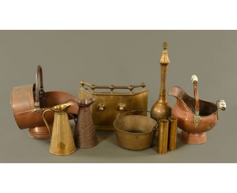 A Victorian copper coal helmet, a brass fire front, two jugs, two shell cases, pair of candlesticks, chamber stick and lamp.