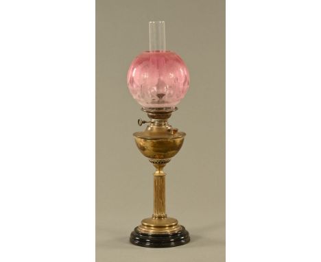 A Victorian brass oil lamp, with cranberry glass shade.  Height including chimney 71 cm. CONDITION REPORT: The shade is in ge