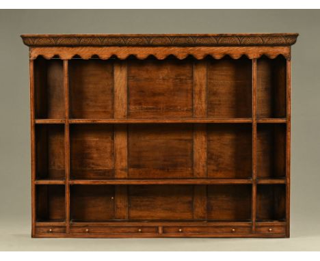 An oak Delft rack, with panelled back and series of open shelves with spice drawers beneath.  Height 133 cm, width 176 cm, de