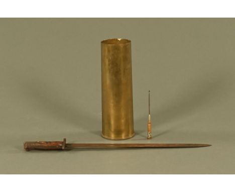 A First World War bayonet, with Trench Art Swastika button hook and a shell case.  Bayonet length 55 cm.