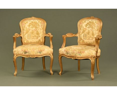 A pair of gilt painted wooden open armchairs, with tapestry backs and seats and raised on front cabriole legs.  Height 86 cm,