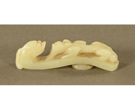 A Chinese carved jade button hook, carved with a Chilong. Length 8 cm.