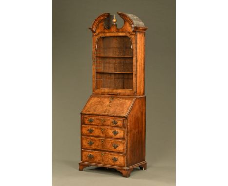 An early 18th century Georgian walnut bureau bookcase, of narrow proportions with architectural pediment (glass missing).  He