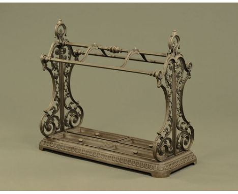 A Victorian style cast metal country house stick stand, with six apertures and detachable drip trays.  Height 81 cm, width 92