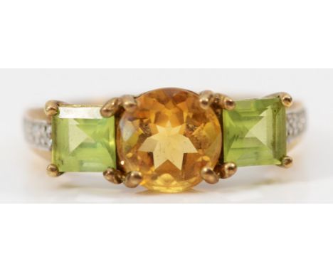 A 9ct gold citrine and peridot three stone ring, diamond set shoulders, R, 3.3gm 