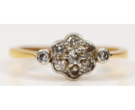 An Edwardian 18ct gold and platinum diamond cluster ring, diamond set shoulders, O, 2.8gm 