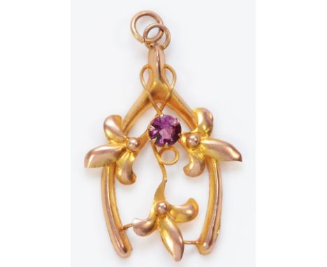 An Edwardian 9ct rose gold floral wishbone pendant, set with an amethyst, by A.J.C. stamped 9ct, 29mm, 1gm 