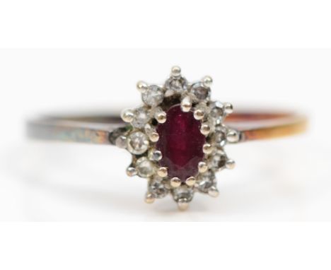 An 18ct gold ruby and diamond cluster ring, N 1/2, 2.1g 