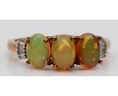 A 9ct gold three stone opal ring , baguette cut diamond set shoulders, P 1/2, 2.6gm 