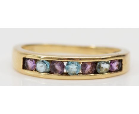 A 9ct gold, amethyst and topaz channel set ring, J 1/2, 1.6gm 