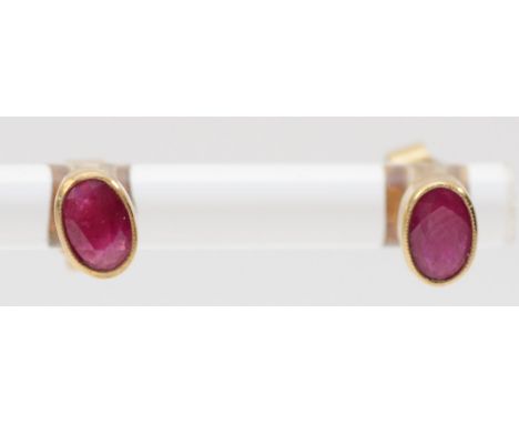 A 9ct gold pair of 6mm ruby ear studs, 0.9gm 