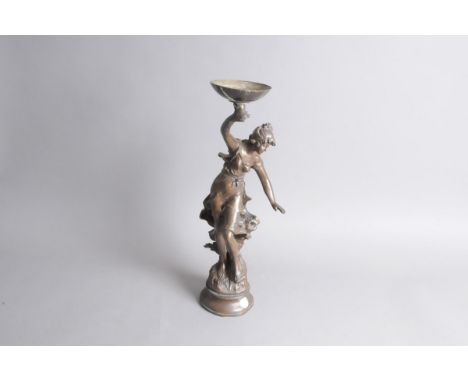A reproduction spelter bronzed figural lamp base after Louis Moreau, modelled as a young lady holding aloft a lamp shade supp