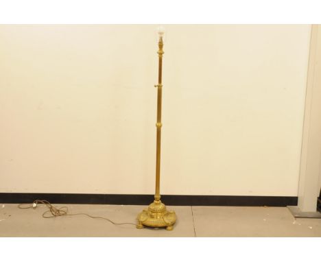 A Victorian brass standard lamp, 140cm to light fitting, with cast iron in base, appears to adjust 