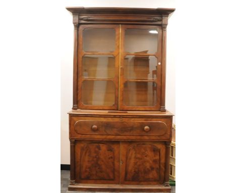 A 19th century figured mahogany secretary bookcase, the top section having a moulded cornice above a pair of six light glazed