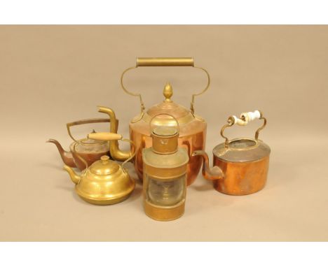 A vintage copper boat or other oil lamp, together with three copper style kettles and a brass example 