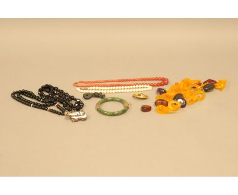 Nine vintage and modern items of jewellery, including a Chinese spinach jadeite bangle with probably gold mounts, a hardstone