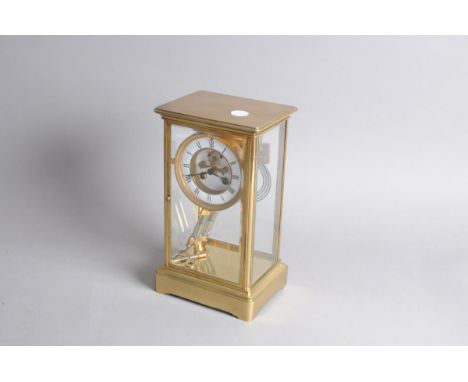 A c1960s brass timepiece, white enamel dial and having mercury within pendulum, 30cm 