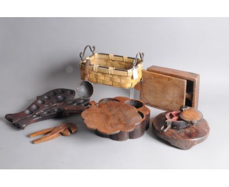 Seven vintage hard wood artifacts, including a fish shaped item with hinges opening to reveal compartmemts, two covered spice