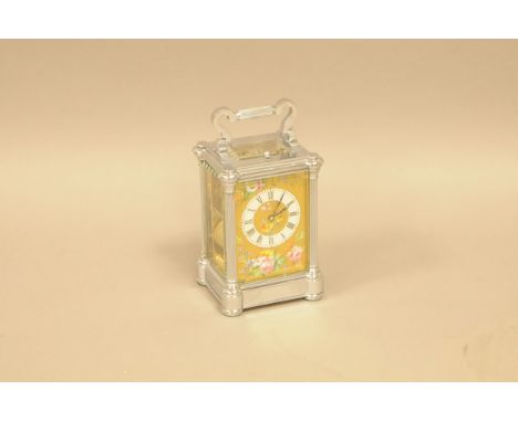 A nice early 20th century repeater carriage timepiece, in silvered case, with handle 18.5cm, with gilt dial painted with flow