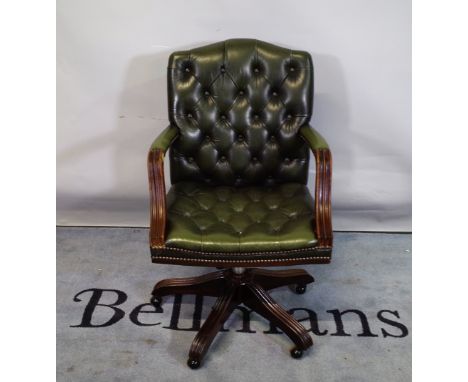 A 20th century Gainsborough style office open armchair with faux green leather button back upholstery. 