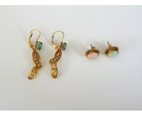 A pair of 9ct gold and opal single stone earstuds, each mounted with an oval opal within a ropetwist wirework surround, the b