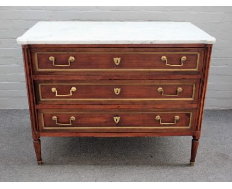 An early 19th century commode, the marble top over gilt metal mounted three drawer base, flanked by fluted columns, 109cm wid