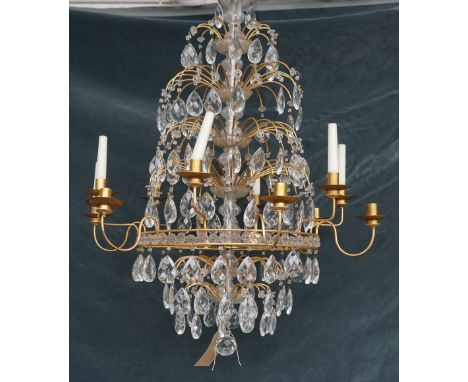 A Baltic style gilt metal and cut glass twelve light chandelier, with plain arms and nozzles, hung with pear shaped drops, 88