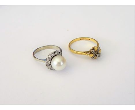 A white gold, cultured pearl and diamond ring, mounted with the cultured pearl to the centre and with ten circular cut diamon