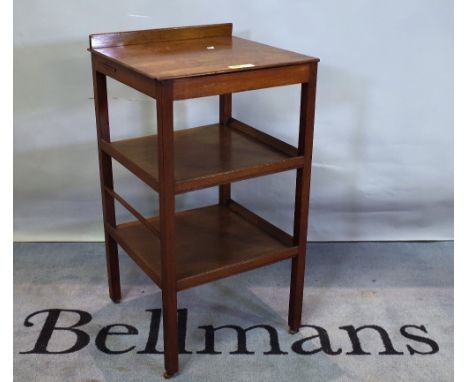 A George III "Country House" mahogany whatnot, adjustable hinged top with separate rest above tiers, brass roller castors, 47