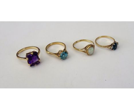 A gold ring, claw set with a rectangular step cut amethyst, detailed 9 CT, a gold ring, claw set with a circular cut blue zir