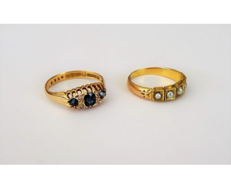 An 18ct gold, sapphire and diamond ring, mounted with three cushion shaped sapphires and with two pairs of small cushion shap