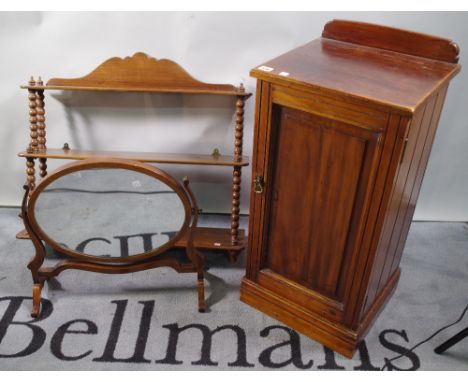 An Edwardian mahogany pot cupboard, 38cm wide, a mahogany three tier wall shelf, 76cm wide, and an oval dressing table mirror