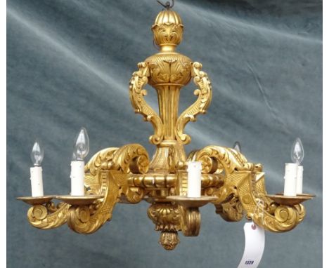 An 18th century style eight branch giltwood chandelier, modern, of carved foliate form, 66cm high. 