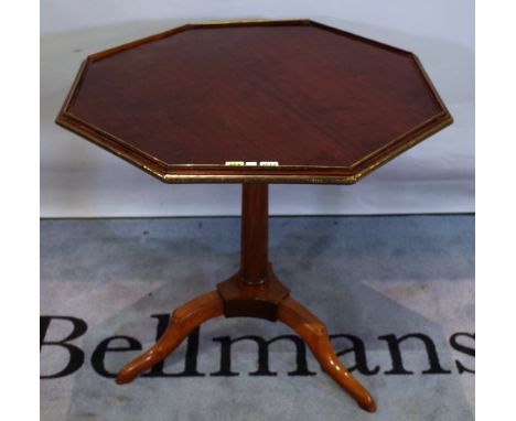 A late Louis XVI brass mounted mahogany tripod occasional table with octagonal snap top, 79cm wide x 76cm high. 