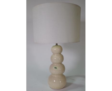 Lighting, comprising; a 20th century cream ceramic crackle glaze table lamp with white silk shade and a white painted standar