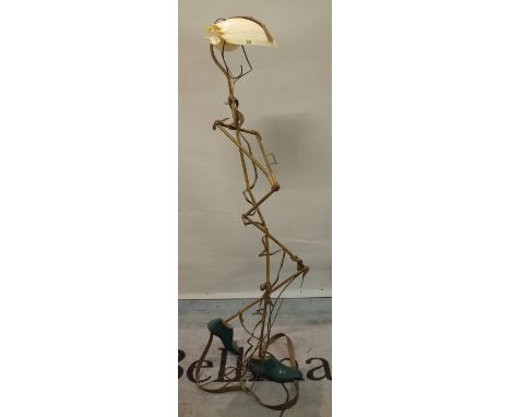 A 20th century abstract copper standard lamp in the form of a standing man with shell shade, 165cm high. Provenance; property